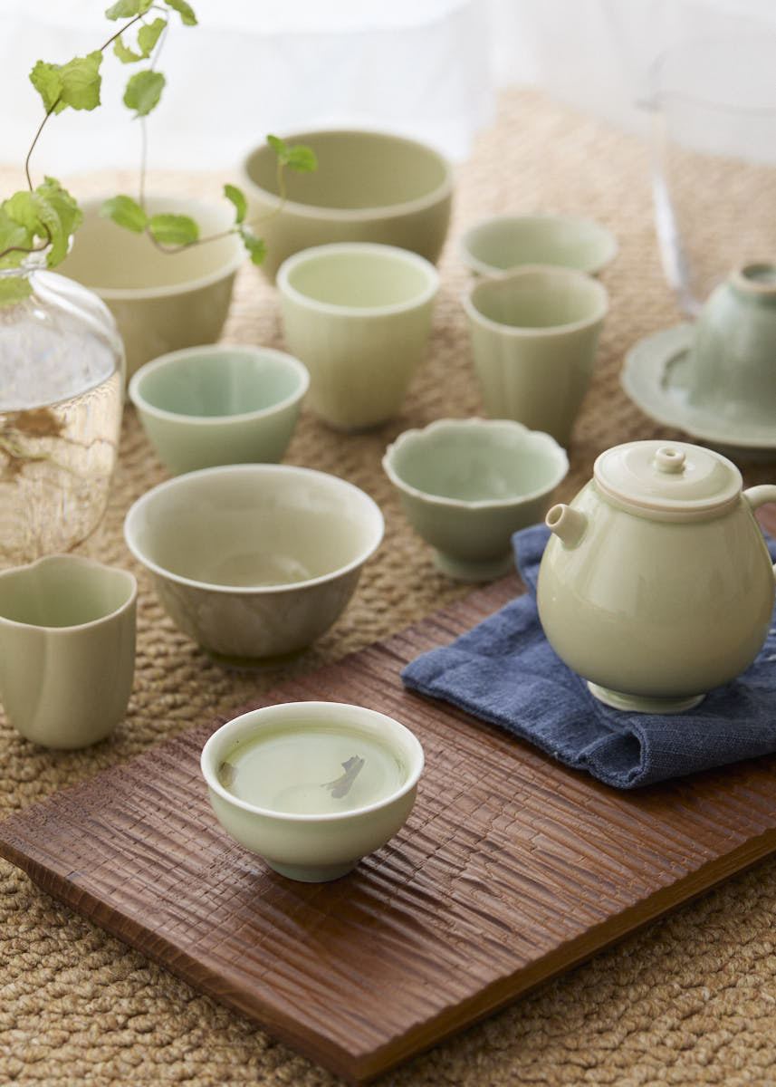 A collection of various handmade ceramic small tea cups including a Gaiwan, a Zen bowl, and a Dragon Egg cup.