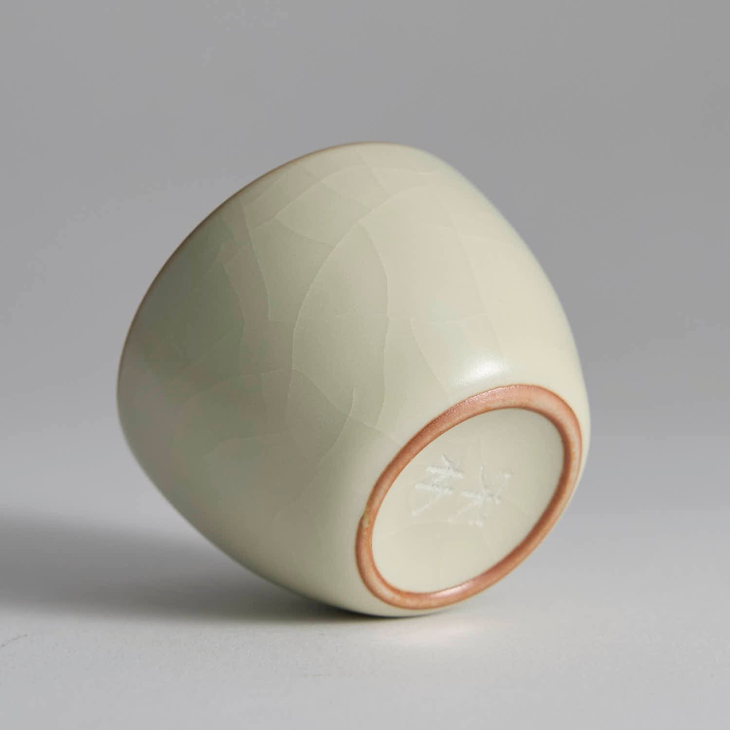 Close-up of Ru Kiln celadon crackle glaze texture, showing delicate ice-crack patterns and soft jade-like sheen