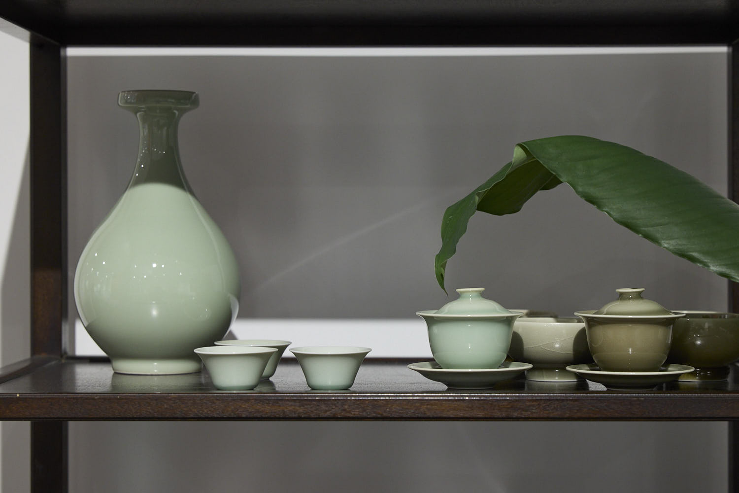A full display of Ou Kiln celadon tea set on a table, including cups, teapots, and gaiwans, showcasing traditional Chinese craftsmanship and elegant tea culture