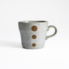 White crackle glaze coffee cup with smooth texture and black speckles