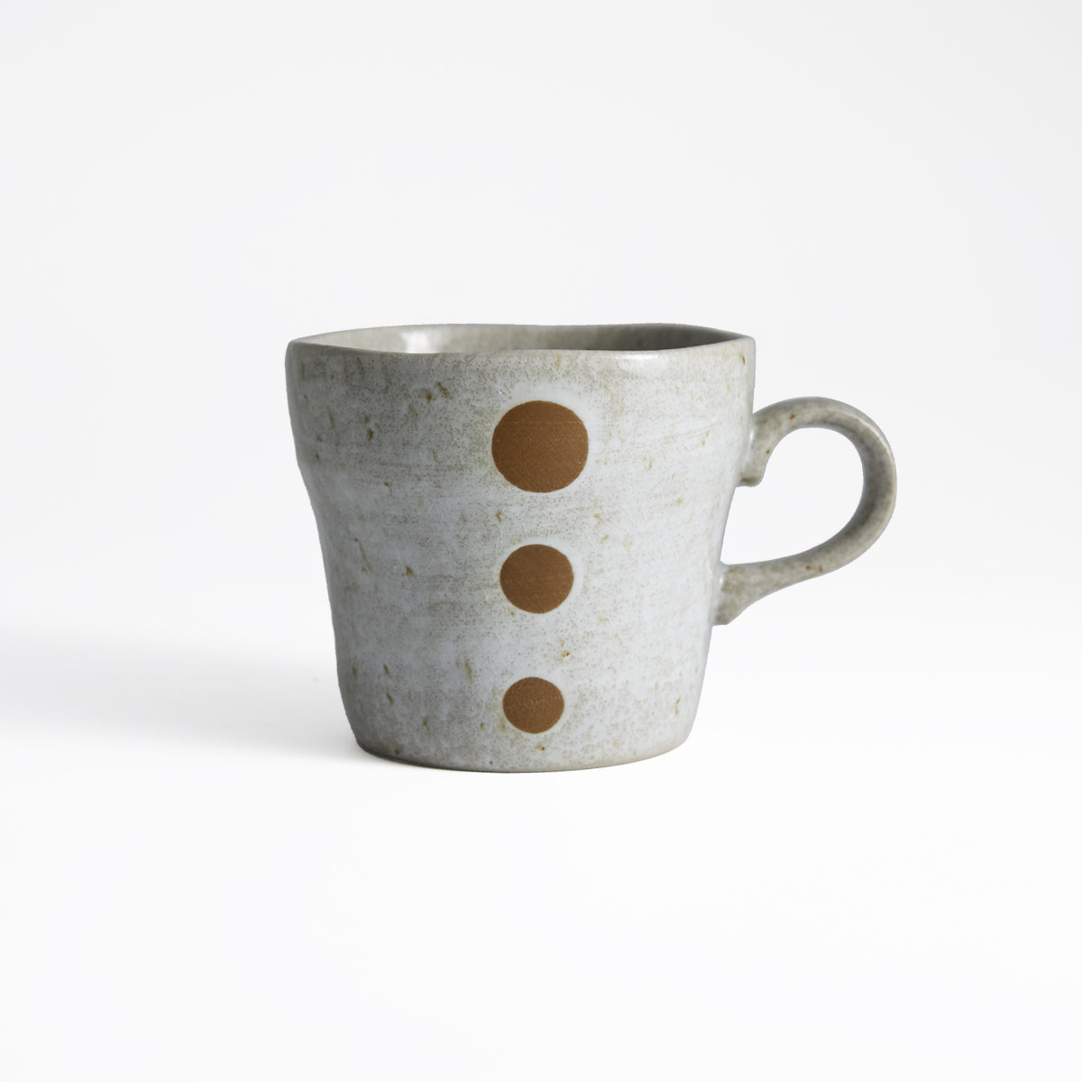 White crackle glaze coffee cup with smooth texture and black speckles