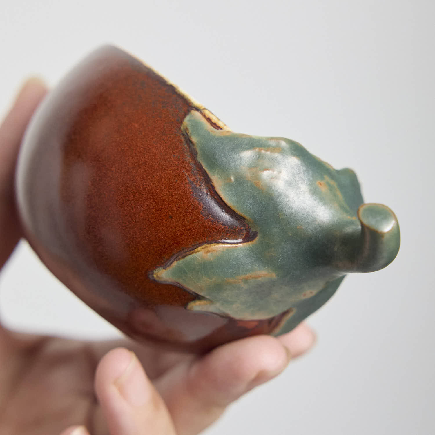 Handcrafted Hagi Ware teacup with eggplant-inspired form and natural clay texture