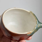 Handcrafted Hagi Ware teacup with eggplant-inspired form and natural clay texture