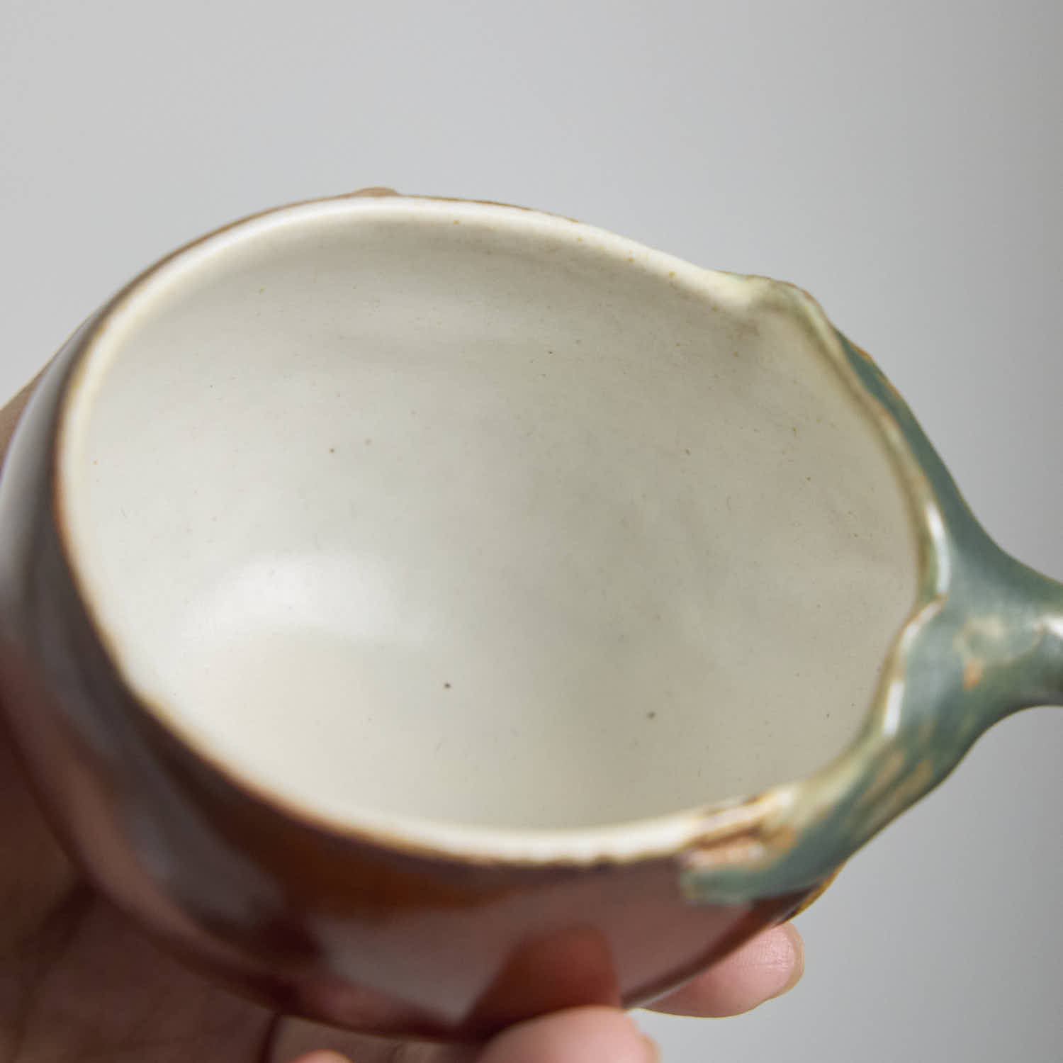 Handcrafted Hagi Ware teacup with eggplant-inspired form and natural clay texture