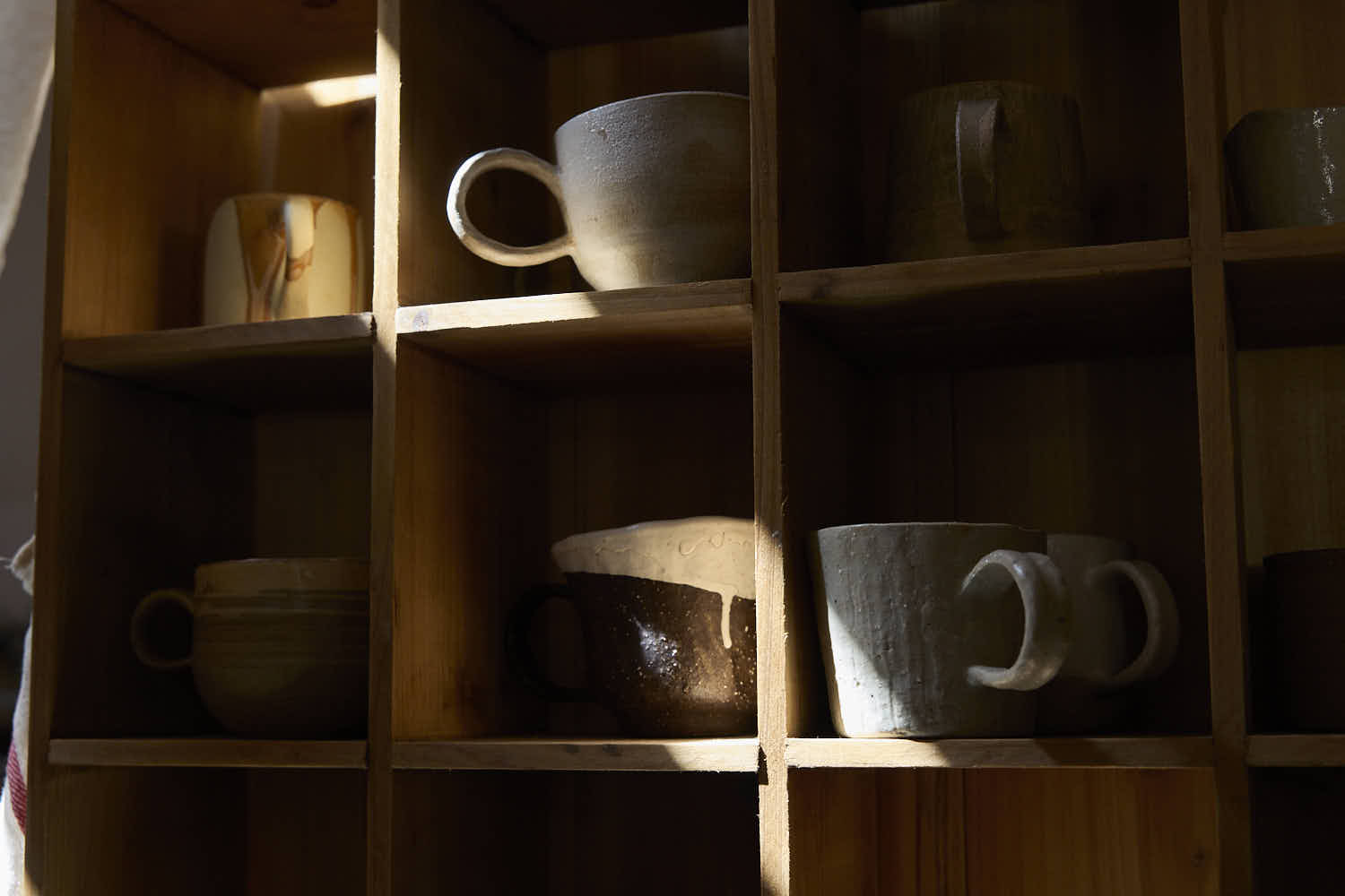 RouseClay - A curated collection of artisan ceramic tea sets and handmade pottery, featuring unique crackle glaze and hand-pinched cups on a serene tabletop.