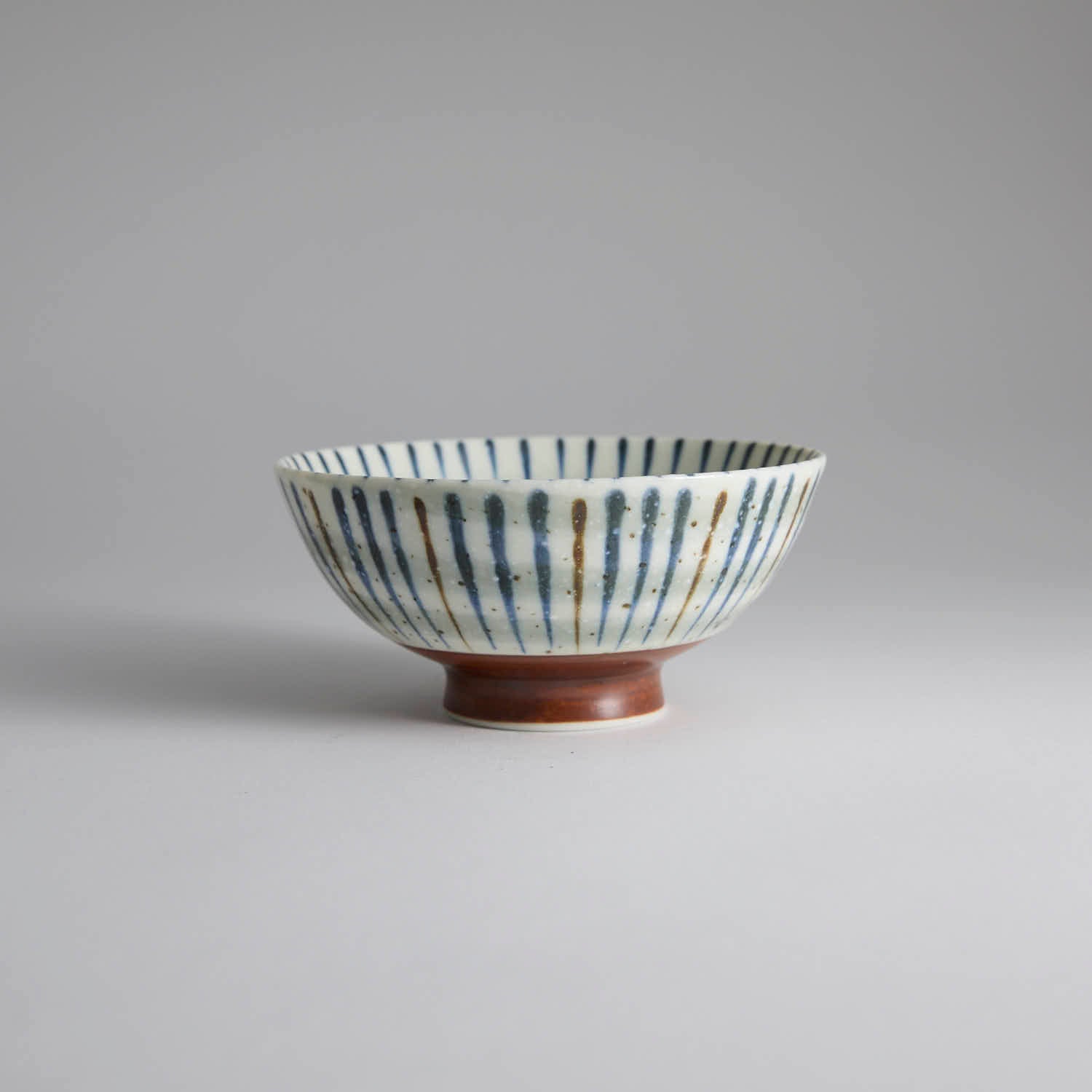 Japanese ceramic bowl with hand-painted striped pattern