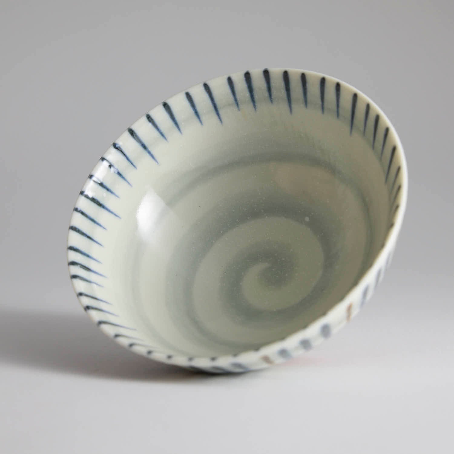 Japanese ceramic bowl with hand-painted striped pattern