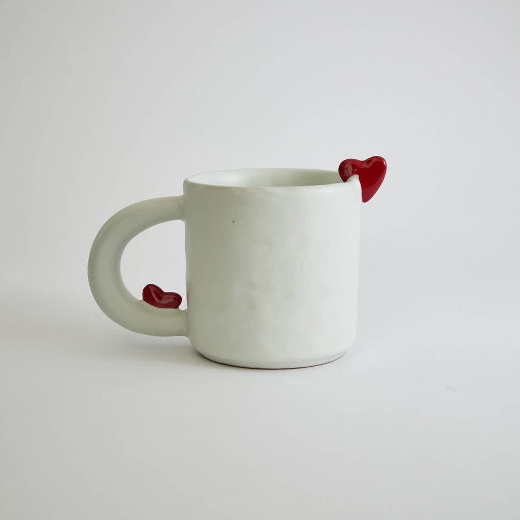 Ceramic mug with heart-shaped design and smooth finish
