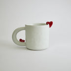Ceramic mug with heart-shaped design and smooth finish
