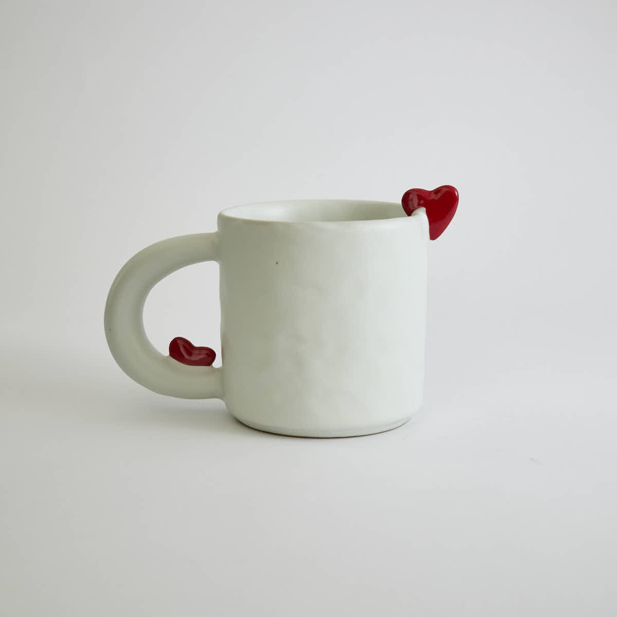 Ceramic mug with heart-shaped design and smooth finish