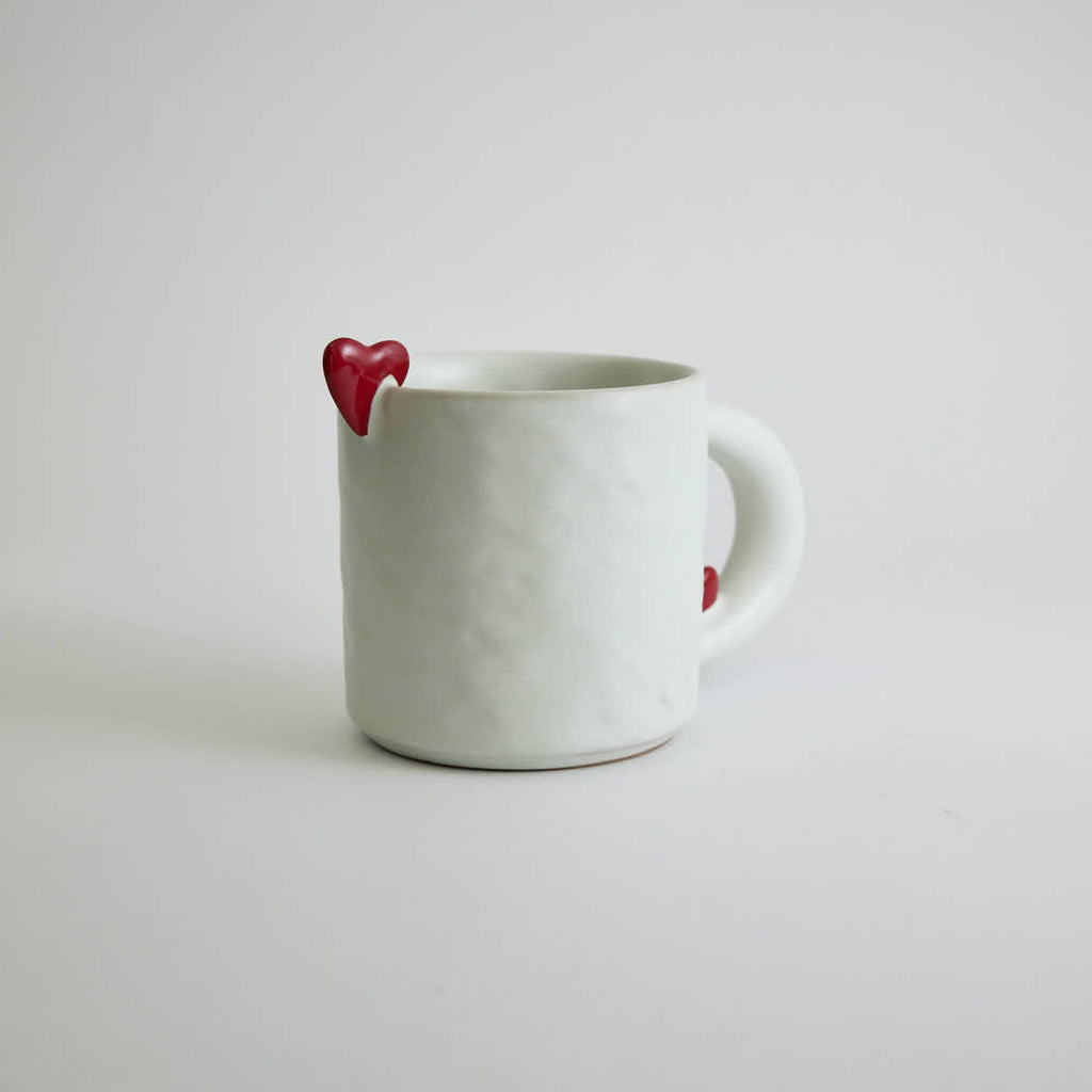 Ceramic mug with heart-shaped design and smooth finish
