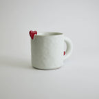 Ceramic mug with heart-shaped design and smooth finish