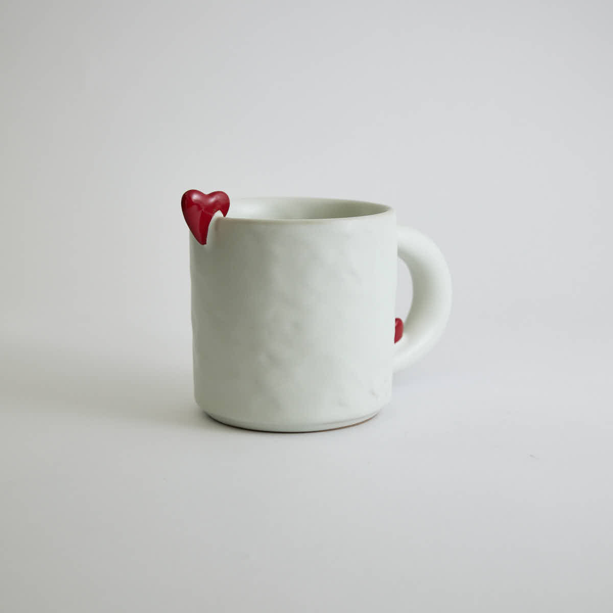 Ceramic mug with heart-shaped design and smooth finish