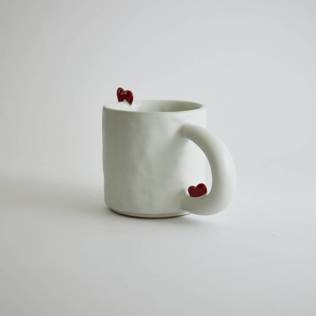 Ceramic mug with heart-shaped design and smooth finish