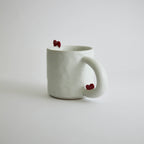 Ceramic mug with heart-shaped design and smooth finish