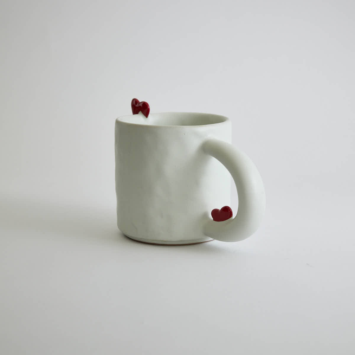Ceramic mug with heart-shaped design and smooth finish