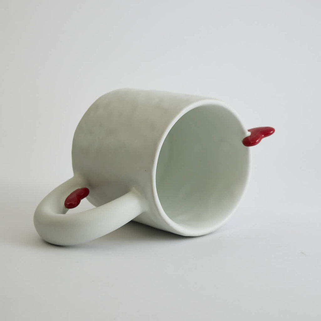 Ceramic mug with heart-shaped design and smooth finish