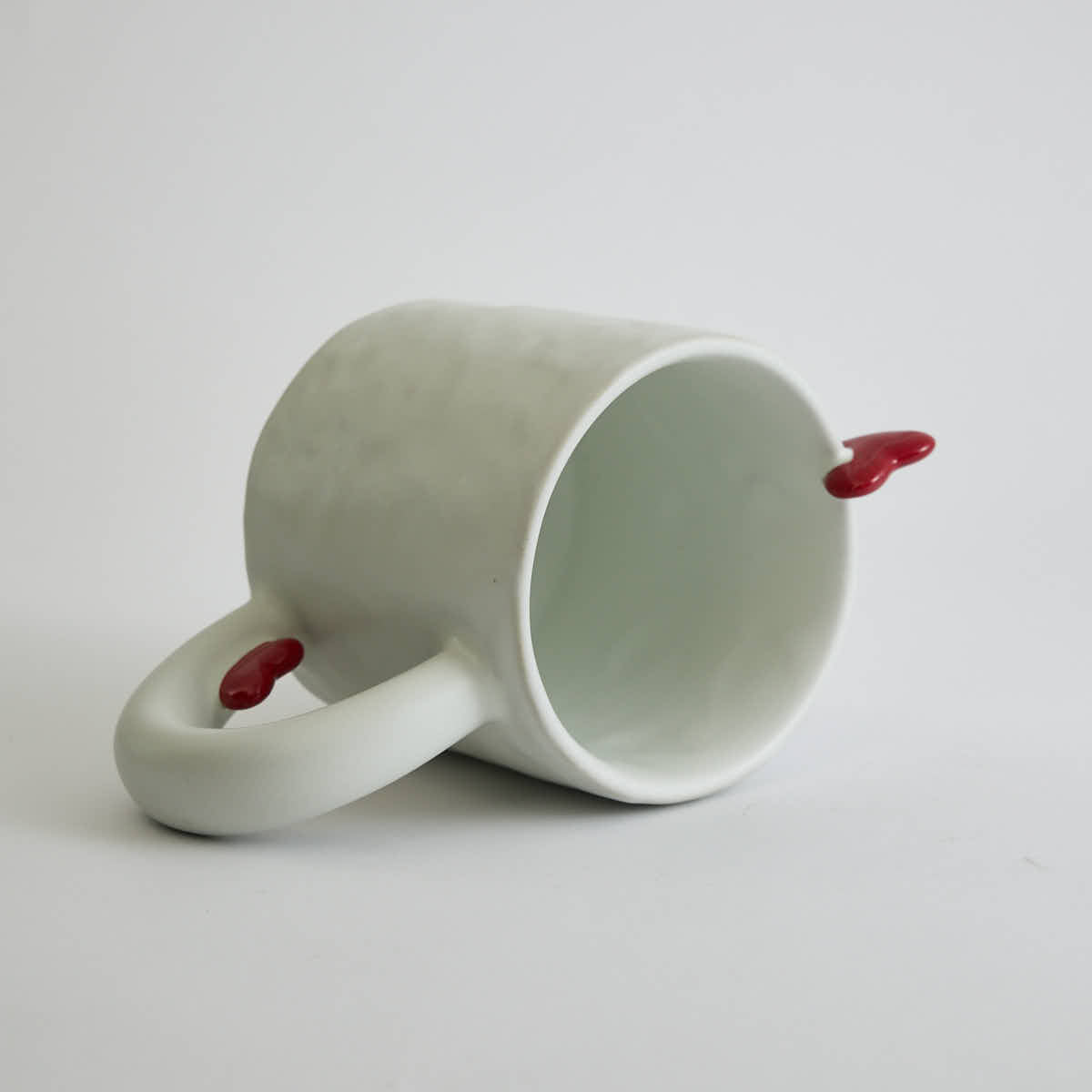 Ceramic mug with heart-shaped design and smooth finish