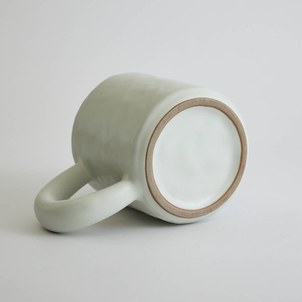 Ceramic mug with heart-shaped design and smooth finish
