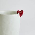 Ceramic mug with heart-shaped design and smooth finish
