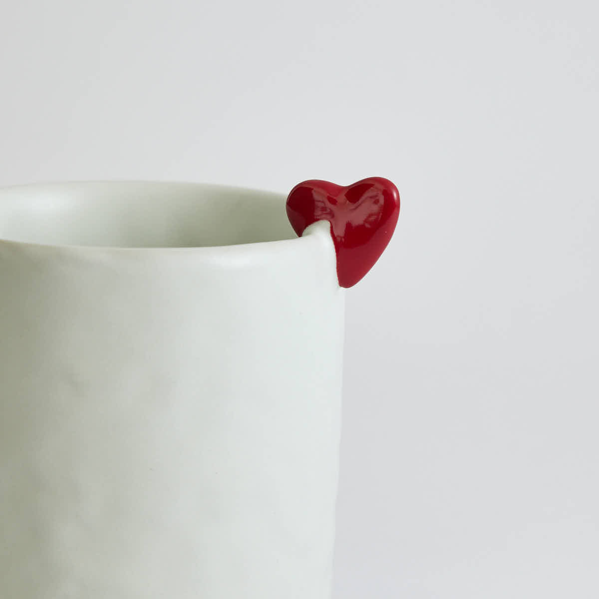 Ceramic mug with heart-shaped design and smooth finish