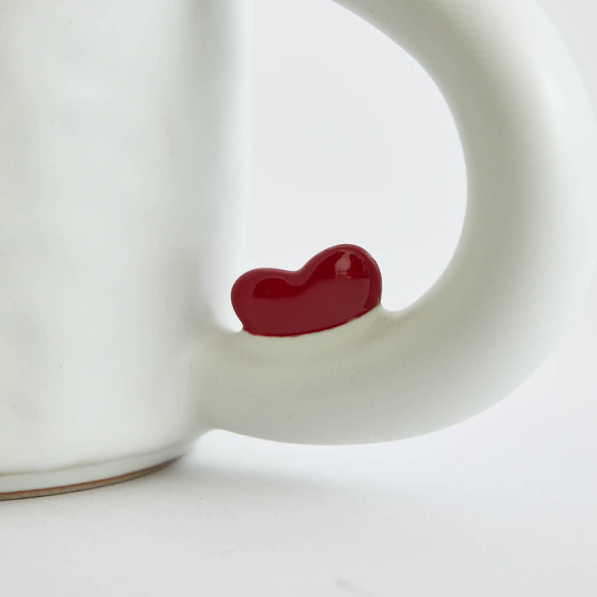 Ceramic mug with heart-shaped design and smooth finish