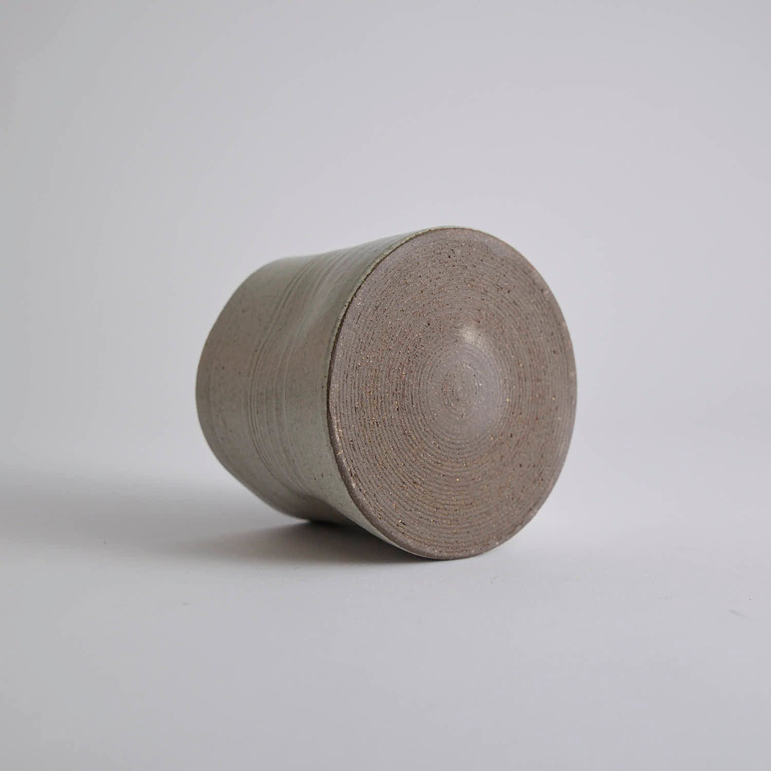 Handcrafted kiln-varied coffee cup with square rim and natural speckled texture