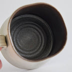 Handcrafted kiln-varied coffee cup with square rim and natural speckled texture