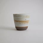 Thick-walled stoneware mug with natural coarse clay texture