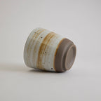 Thick-walled stoneware mug with natural coarse clay texture