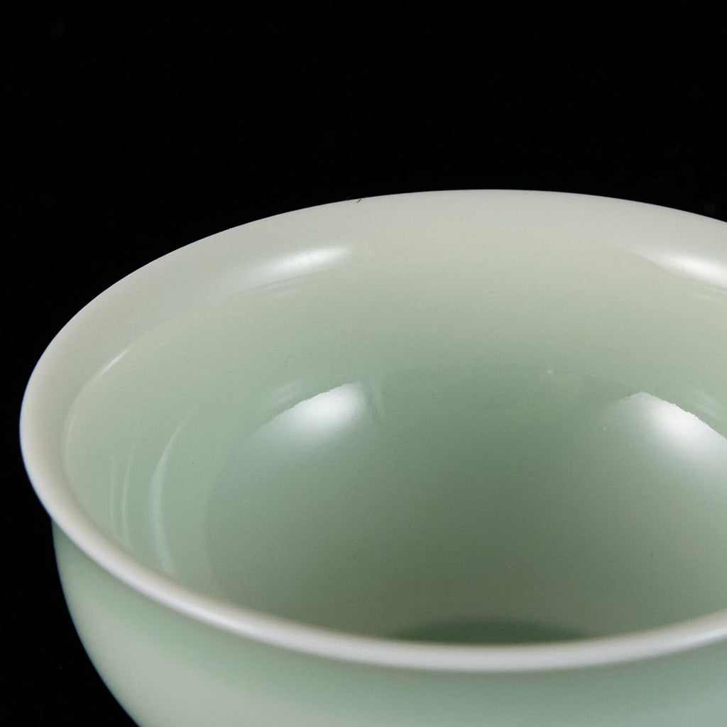 Ou Kiln open-rim celadon teacup with a smooth jade-like glaze and minimalist bowl-shaped design.