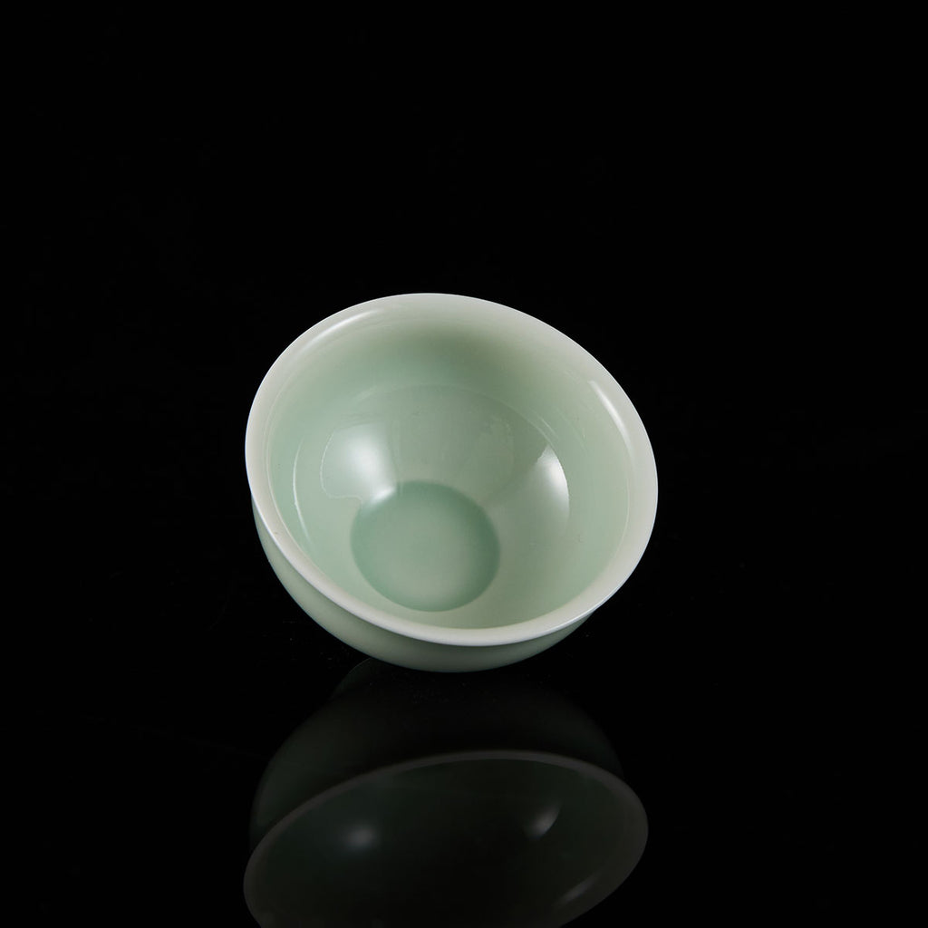 Ou Kiln open-rim celadon teacup with a smooth jade-like glaze and minimalist bowl-shaped design.