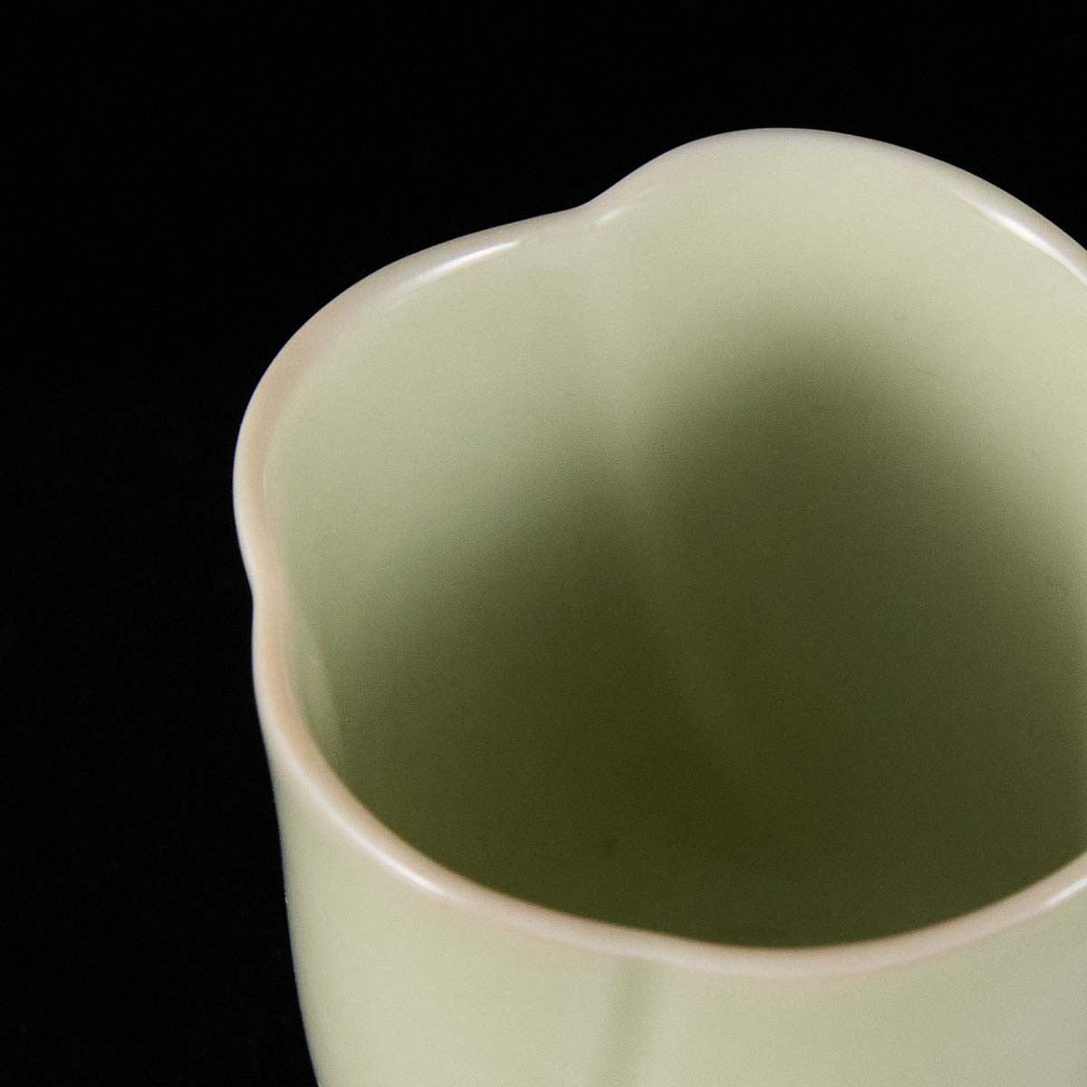 Ou Kiln five-petal blossom rim teacup with wave-shaped floral edge and elegant ceramic finish.