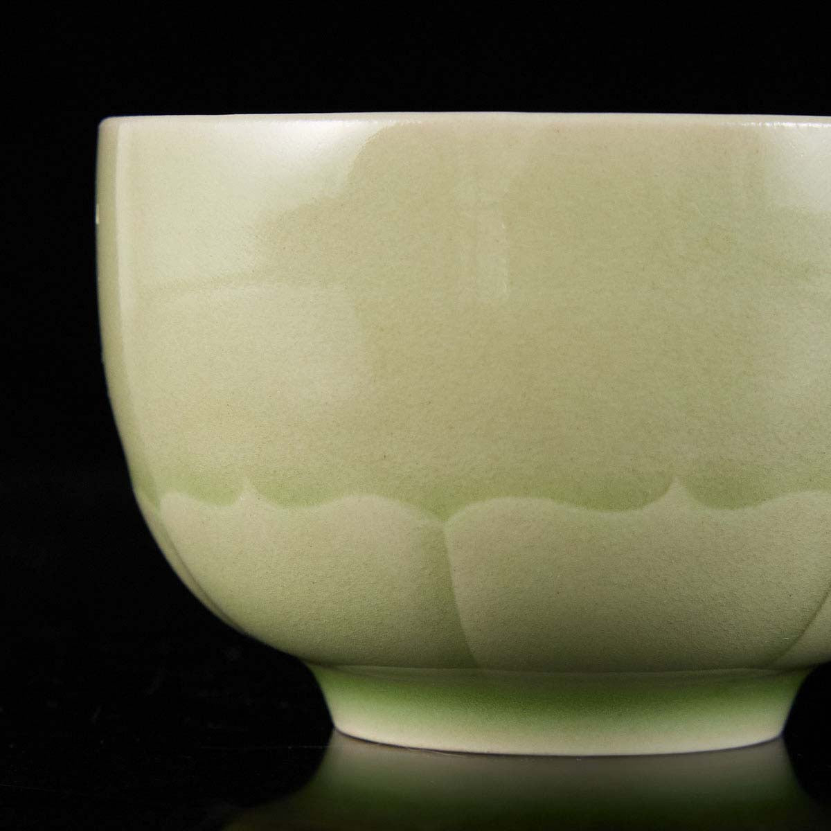 Handcrafted porcelain with layered lotus petal texture in traditional Chinese celadon style