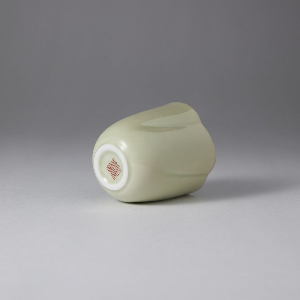 Ou Kiln five-petal blossom rim teacup with wave-shaped floral edge and elegant ceramic finish.