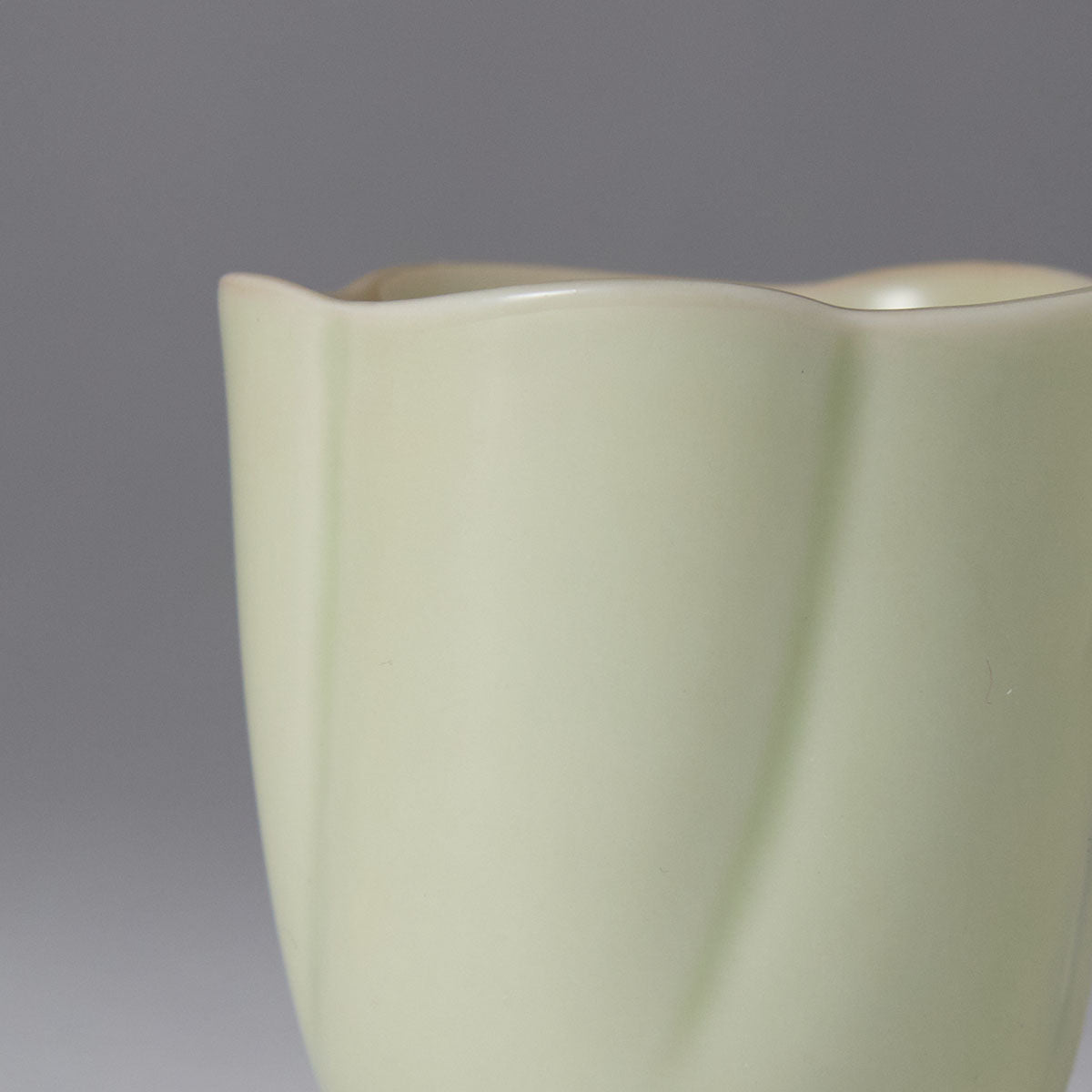 Ou Kiln five-petal blossom rim teacup with wave-shaped floral edge and elegant ceramic finish.