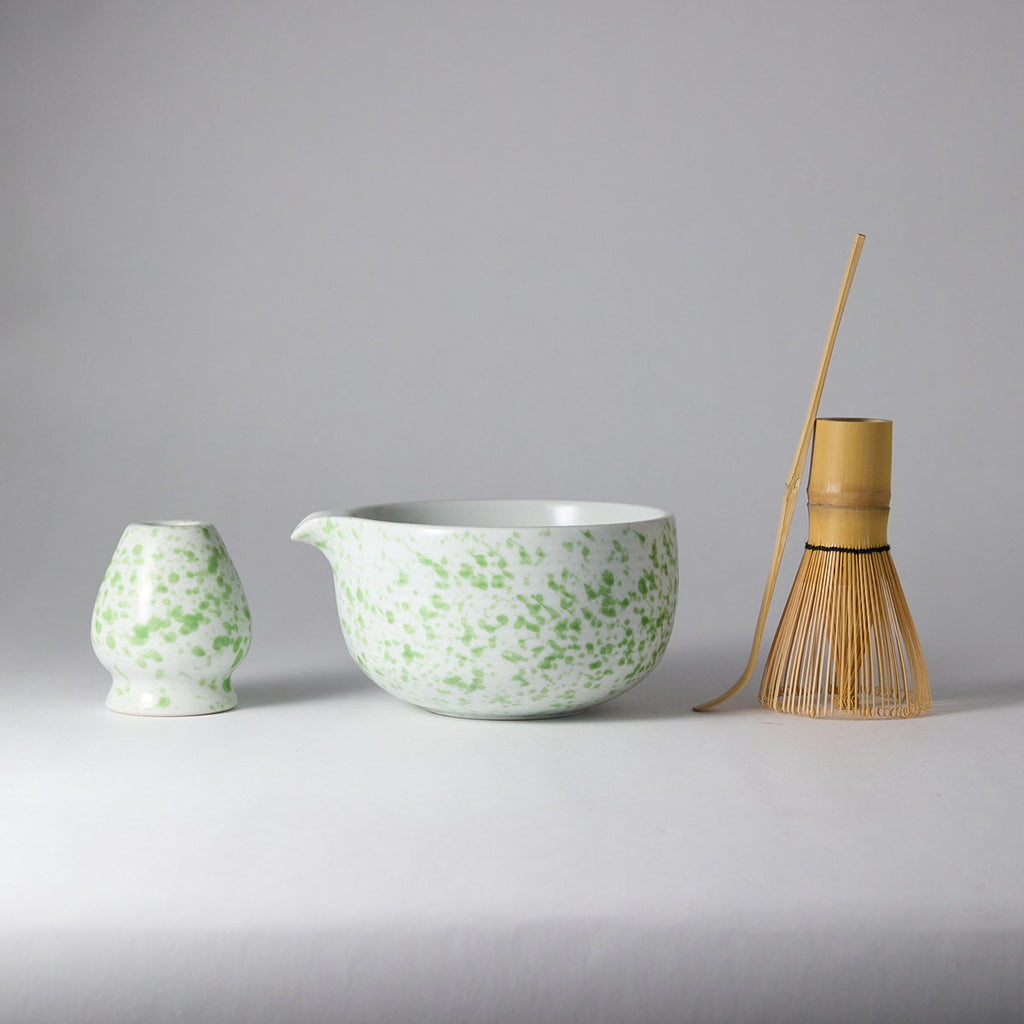 Galaxy-speckled matcha tea set with chawan, bamboo whisk, stand, and scoop