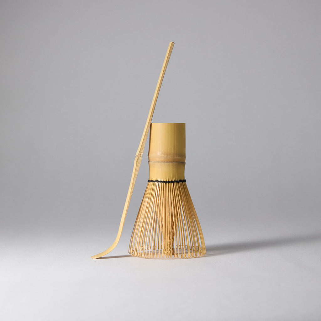Galaxy-speckled matcha tea set with chawan, bamboo whisk, stand, and scoop