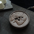 Handmade teapot stand with a persimmon design that can hold water.