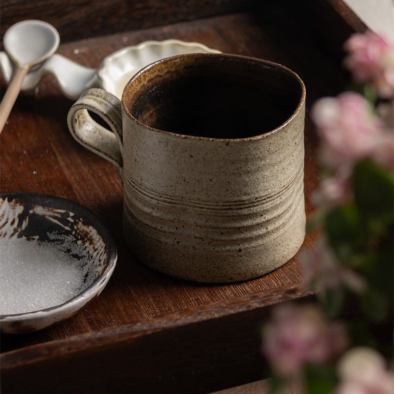 Handcrafted kiln-varied coffee cup with square rim and natural speckled texture